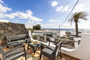 a balcony with benches and a view of the beach at Villa Atlantico - Villasexperience in Arrecife
