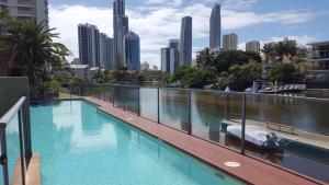a swimming pool with a city skyline in the background at New 2 Bedroom 2 Bathroom Apartment in Gold Coast