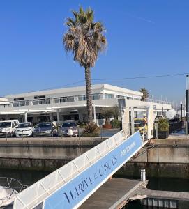 a ramp leading to a parking lot with a palm tree at Payva & Branco Boats Iate privado em Cascais in Cascais