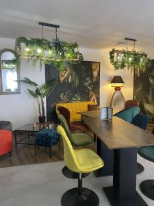 a room with colorful chairs and a table at Fasthotel Mont de Marsan in Mont-de-Marsan