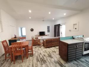 a kitchen and living room with a table and a dining room at 34 Hornbill Street in St Lucia