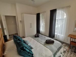 a bedroom with a large bed with pillows on it at 34 Hornbill Street in St Lucia