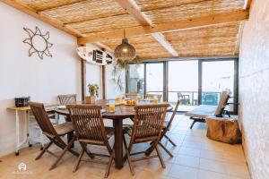 a dining room with a table and chairs at Casa da Torre - BBQ and Terrace in Santa Cruz