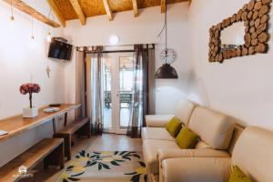 a living room with a couch and a table at Casa da Torre - BBQ and Terrace in Santa Cruz