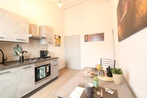 a kitchen with a table and a stove top oven at Nora's House in Siena +34 photos