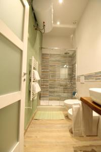 a bathroom with a toilet and a sink and a shower at Nora's House in Siena