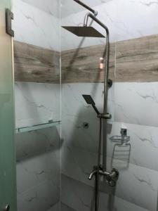 a shower with a shower head in a bathroom at Montrose Gardens in Lagos