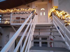 a stairway with christmas lights and a door at Apartment Ada bed & breakfast in Gračac