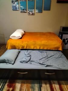 two beds sitting next to each other in a room at LOFT PLAYAS "A" , a unos pasos del malecon estadio acuario y letras in Mazatlán