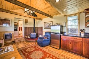 a kitchen and living room with a refrigerator and a stove at Idyllic Dolores Cabin with Fire Pit and Lake Views! in Dolores