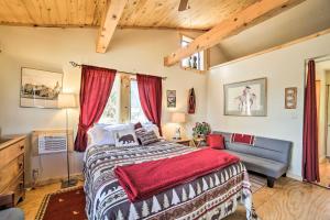 a bedroom with a bed and a couch at Idyllic Dolores Cabin with Fire Pit and Lake Views! in Dolores