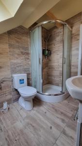 a bathroom with a shower and a toilet and a sink at Apartmány Sebastián in Pribylina
