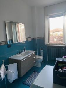 a blue bathroom with a sink and a toilet at La casa di Marta in Valeggio sul Mincio