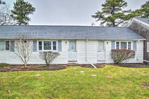 a white house with a yard at Cape Cod Vacation Rental Walk to Beach! in Dennis Port