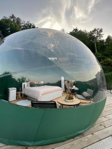 a large glass dome with a bed and a bedroom at Bulle Time Flies - logement insolite in Bouillon