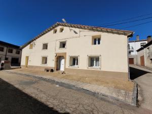 un edificio blanco al lado de una calle en El Refugio de Abejar, en Abejar