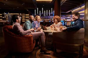 a group of people sitting around a table in a bar at SAHARA Las Vegas in Las Vegas