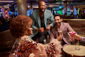 a group of people drinking at a bar at SAHARA Las Vegas in Las Vegas