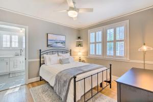 a bedroom with a bed with a ceiling fan and windows at Columbia Vacation Rental Less Than 2 Mi to University in Columbia