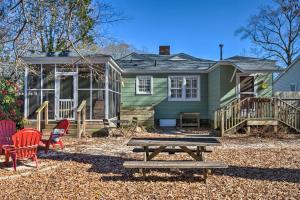a green house with a picnic table and chairs at Columbia Vacation Rental Less Than 2 Mi to University in Columbia