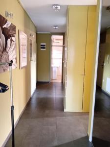 a hallway in a building with yellow walls and tile floors at Apartment Laura in Pula