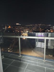 a balcony with a view of a city at night at Daire in Štip