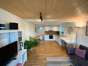 ein großes Wohnzimmer mit einem Sofa und einer Küche in der Unterkunft Ferienwohnung Weitblick in Ravensburg