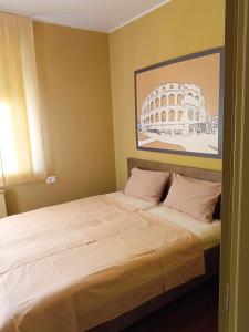 a bedroom with a bed with a picture of the coliseum at Apartment Laura in Pula