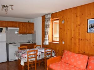 a kitchen and dining room with a table and a couch at Appartement cosy avec balcon, 300m du centre, proche commerces et pistes, piscine chauffée - FR-1-464-157 in Pralognan-la-Vanoise +7 photos