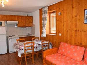 a kitchen and dining room with a table and a couch at Appartement cosy avec balcon, 300m du centre, proche commerces et pistes, piscine chauffée - FR-1-464-157 in Pralognan-la-Vanoise
