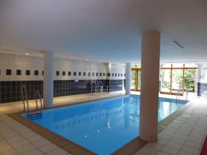 - une grande piscine d'eau bleue dans un bâtiment dans l'établissement Appartement Pralognan-la-Vanoise, 3 pièces, 4 personnes - FR-1-464-157, à Pralognan-la-Vanoise