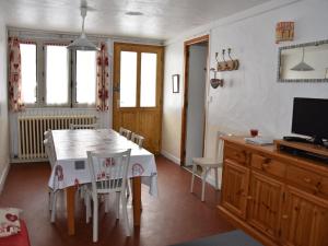 a dining room with a table and chairs and a television at Appartement Pralognan-la-Vanoise, 3 pièces, 6 personnes - FR-1-464-154 in Pralognan-la-Vanoise