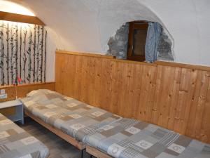 a bedroom with two beds and a tv on the wall at Appartement Pralognan-la-Vanoise, 3 pièces, 6 personnes - FR-1-464-154 in Pralognan-la-Vanoise