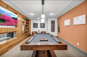 a pool table in a living room with a tv at Palatial Abode Nashville With Downtown View & Free Parking in Nashville