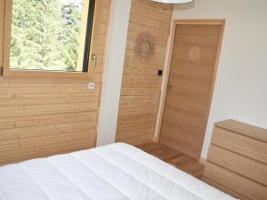 a bedroom with a bed and a window and a door at Chalet Pralognan-la-Vanoise, 4 pièces, 8 personnes - FR-1-464-189 in Pralognan-la-Vanoise