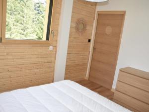 a bedroom with a bed and a window and a door at Chalet récent proche centre, piscine et patinoire, avec terrasse et parking couvert - FR-1-464-189 in Pralognan-la-Vanoise