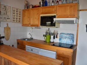 a kitchen with wooden cabinets and a counter top at Appartement Pralognan-la-Vanoise, 4 pièces, 6 personnes - FR-1-464-193 in Pralognan-la-Vanoise