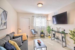 a living room with a couch and a flat screen tv at Fort Lauderdale Apt Near Beaches and Shopping! in Fort Lauderdale