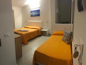 Postel nebo postele na pokoji v ubytování Valle degli Ulivi B&B