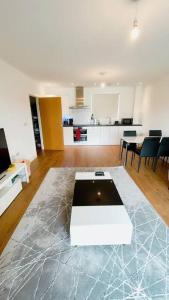 a living room with a white table on a marble floor at Modern One Bedroom Luxury Apartment in Colindale