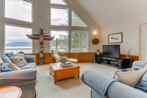a living room with two couches and a tv at Shoal Bay Luxury Home in Port Stanley