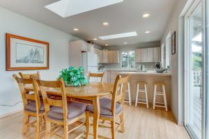 a kitchen and dining room with a wooden table and chairs at Shoal Bay Luxury Home in Port Stanley