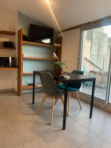 a dining room with a table and two chairs at Studio avec Terrasse in Aix-en-Provence