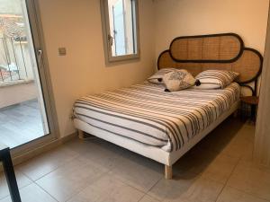 a bed with two pillows on it in a room at Studio avec Terrasse in Aix-en-Provence