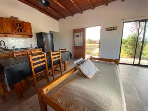 a room with a kitchen and a bed in a room at Casa Nekay in San Lorenzo