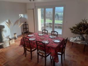 a dining room with a table and chairs and a window at La cantinière in Fougerolles