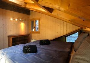 a bedroom with a blue bed in a attic at Le Dernier Mot in Bruson