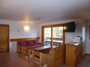 a living room with a couch and a table at Appartement Champagny-en-Vanoise, 4 pièces, 8 personnes - FR-1-464-37 in Champagny-en-Vanoise