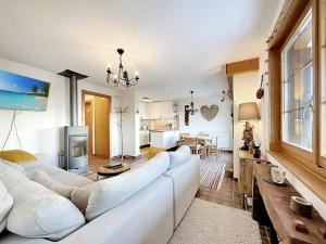 a living room with a white couch and a table at Our little marmots' dream in Bruson