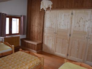 プラローニャン・ラ・ヴァノワーズにあるChalet Pralognan-la-Vanoise, 5 pièces, 8 personnes - FR-1-464-48の木製のキャビネット、椅子、テーブルが備わる客室です。
